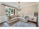 Comfortable living room featuring a sectional sofa and natural light at 6185 Masters Club Dr, Suwanee, GA 30024