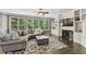 Spacious living room with a fireplace, built-in shelving, and comfortable seating at 6185 Masters Club Dr, Suwanee, GA 30024