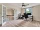 Bright office space features a ceiling fan, neutral carpet and french doors leading to the hallway at 6185 Masters Club Dr, Suwanee, GA 30024