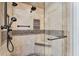 Custom tiled shower with glass door, shower seat and upgraded shower head at 6185 Masters Club Dr, Suwanee, GA 30024