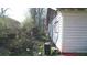 Side yard showing exterior and overgrown landscaping at 692 Moreland Se Ave, Atlanta, GA 30316