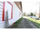 Side view of a white house with red trim and a gravel driveway at 692 Moreland Se Ave, Atlanta, GA 30316