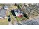 Aerial view of a two-story home with a red and white painted exterior amid mature trees at 692 Moreland Se Ave, Atlanta, GA 30316