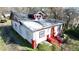 Side view of home with red accents, a small porch, dormer window, and paved driveway at 692 Moreland Se Ave, Atlanta, GA 30316