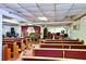Traditional sanctuary featuring rows of seating, a wooden podium, and instruments at 692 Moreland Se Ave, Atlanta, GA 30316