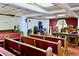 Traditional sanctuary featuring rows of seating, a wooden podium, and instruments at 692 Moreland Se Ave, Atlanta, GA 30316