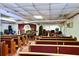 Traditional sanctuary featuring rows of seating, a wooden podium, and instruments at 692 Moreland Se Ave, Atlanta, GA 30316