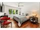 Cozy bedroom with hardwood floors, a large window, and ceiling fan provides natural light at 1164 Bonview Ne Ln, Atlanta, GA 30324