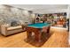Entertaining billiard room featuring a jukebox, stone accent wall, and a retro-style record collection at 1164 Bonview Ne Ln, Atlanta, GA 30324