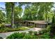Charming single-story home with stone facade, modern garage door, mature landscaping, and curved driveway at 1164 Bonview Ne Ln, Atlanta, GA 30324