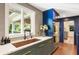 Charming kitchen features a copper sink, stainless steel appliances, and a view to the outdoor porch at 1164 Bonview Ne Ln, Atlanta, GA 30324