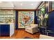 Cozy sitting area features unique artwork, a glass enclosed wine cellar and modern furniture at 1164 Bonview Ne Ln, Atlanta, GA 30324