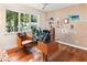 Modern office features a glass desk and two comfortable leather chairs with oversized windows and natural light at 1164 Bonview Ne Ln, Atlanta, GA 30324
