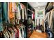 Organized walk-in closet with dark shelving, rods, and hardwood floors provides plenty of space at 1164 Bonview Ne Ln, Atlanta, GA 30324