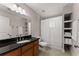 Well-lit bathroom featuring tiled floors, granite countertop, shower, and built-in shelves at 449 Clairemont Ave # H3, Decatur, GA 30030