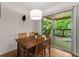 Warm dining room featuring wood table set and sliding door to deck with nature views at 449 Clairemont Ave # H3, Decatur, GA 30030