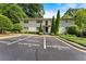 Inviting exterior of a light brick multi-Gathering home with well-maintained landscaping and reserved parking spaces at 449 Clairemont Ave # H3, Decatur, GA 30030