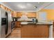 Well-equipped kitchen featuring stainless steel appliances, a breakfast bar and wood cabinets at 449 Clairemont Ave # H3, Decatur, GA 30030