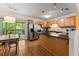Charming kitchen featuring stainless steel appliances, an island with a breakfast bar, and wood cabinets at 449 Clairemont Ave # H3, Decatur, GA 30030