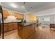 Open-concept kitchen featuring stainless steel appliances, a breakfast bar, and views into the living room at 449 Clairemont Ave # H3, Decatur, GA 30030