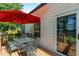 Cozy back deck has dining set, shade umbrella and glass sliding door leading to interior at 1967 Cogar Dr, Decatur, GA 30032