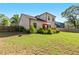 Lush backyard with grass, deck with patio furniture, landscaped flower beds, and fenced perimeter at 1967 Cogar Dr, Decatur, GA 30032