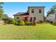 Wide backyard featuring a deck with patio furniture, lush grass, and mature landscaping at 1967 Cogar Dr, Decatur, GA 30032