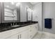 Bathroom featuring double sink vanity with dark countertops, white cabinets, and stylish lighting at 1967 Cogar Dr, Decatur, GA 30032