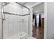 Modern bathroom featuring tiled shower with glass door and view into main bedroom at 1967 Cogar Dr, Decatur, GA 30032