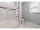 Bright bathroom features tiled shower with glass door, toilet and tile flooring and light paint at 1967 Cogar Dr, Decatur, GA 30032