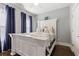 Bedroom includes hardwood floors, blue curtains, and a large bed with plenty of space to relax at 1967 Cogar Dr, Decatur, GA 30032