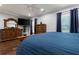 Cozy bedroom with wood floors, dark blue curtains, recessed lighting, and decorative wood furniture at 1967 Cogar Dr, Decatur, GA 30032