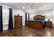 Bedroom with wood floors, recessed lighting, dark blue curtains, and decorative wood furniture at 1967 Cogar Dr, Decatur, GA 30032