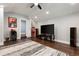 Entertainment room features hardwood floors, a large flatscreen TV, speakers, and custom lighting at 1967 Cogar Dr, Decatur, GA 30032