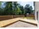 View of wooden deck, patio, and large treed yard at 2720 Meridian Ct, Dacula, GA 30019