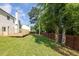 Exterior view of the fenced backyard, wooden deck, and home at 2720 Meridian Ct, Dacula, GA 30019