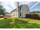 Exterior view of fenced backyard, deck, and home at 2720 Meridian Ct, Dacula, GA 30019