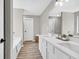 Bathroom showcasing a double sink vanity, framed mirrors and wood-look floors at 2720 Meridian Ct, Dacula, GA 30019