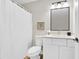 Bathroom features a white vanity with framed mirror and black accents at 2720 Meridian Ct, Dacula, GA 30019