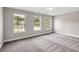 Bedroom featuring three windows and carpet at 2720 Meridian Ct, Dacula, GA 30019