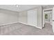 Bedroom with carpet flooring, white trim, and a double door closet at 2720 Meridian Ct, Dacula, GA 30019