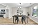 Dining room with modern chandelier, wood-look floors, and large window at 2720 Meridian Ct, Dacula, GA 30019