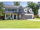 Charming two-story home with black shutters, gray brick, a manicured lawn and an attached garage at 2720 Meridian Ct, Dacula, GA 30019