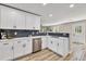 Modern kitchen features white cabinets, stainless steel appliances, and subway tile backsplash at 2720 Meridian Ct, Dacula, GA 30019
