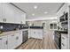 Modern kitchen with white cabinets, stainless steel appliances, and ample countertop space at 2720 Meridian Ct, Dacula, GA 30019