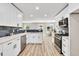 Modern kitchen with white cabinets, stainless steel appliances, and a view into the dining area at 2720 Meridian Ct, Dacula, GA 30019
