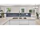 Kitchen sink has stainless steel fixtures, white cabinets, and subway tile backsplash at 2720 Meridian Ct, Dacula, GA 30019