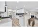 Well-lit kitchen showcasing white cabinets, stainless steel appliances, and a convenient breakfast bar at 2720 Meridian Ct, Dacula, GA 30019
