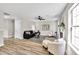 Inviting living room featuring a fireplace, light-colored wood floors, and comfortable seating arrangement at 2720 Meridian Ct, Dacula, GA 30019