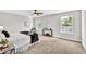 Sunlit main bedroom features carpet flooring, a ceiling fan, and large windows at 2720 Meridian Ct, Dacula, GA 30019